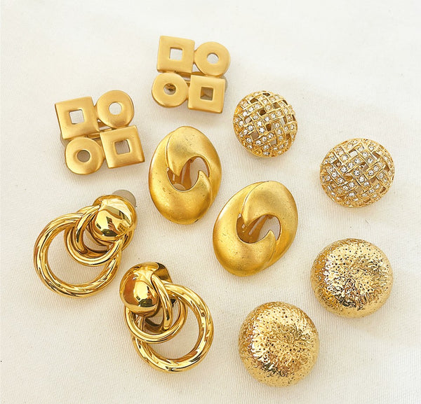 Collection of 5 pairs of gold tone metal vintage designer clip on earrings.