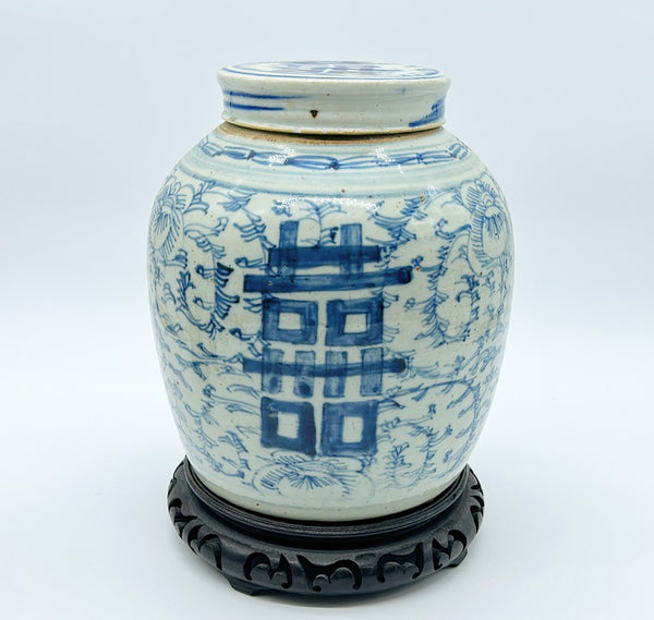 Antique blue and white double happiness ginger jar with lid and wooden carved base.