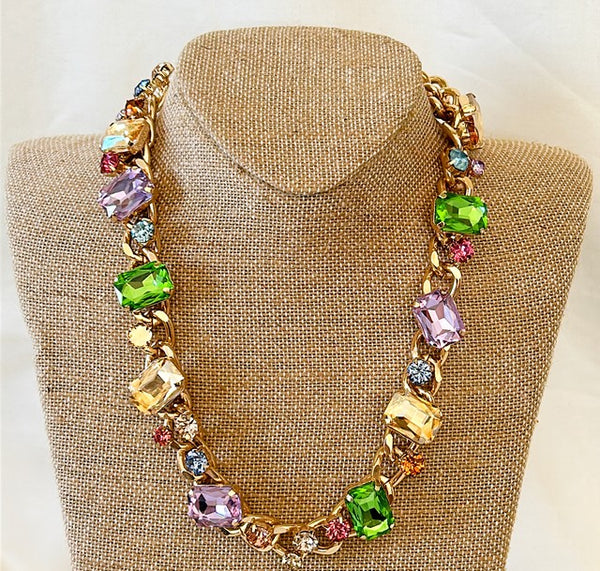 Beautiful chunky multi colored statement necklace with rhinestone mix details .
