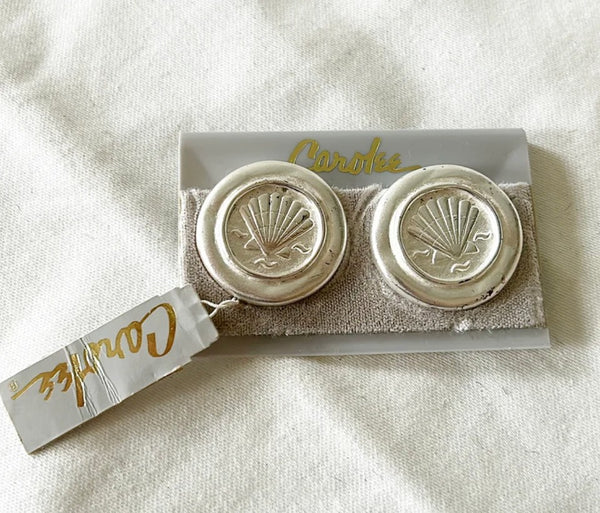 Vintage silver coin style shell clip on Carolee earrings signed in back.