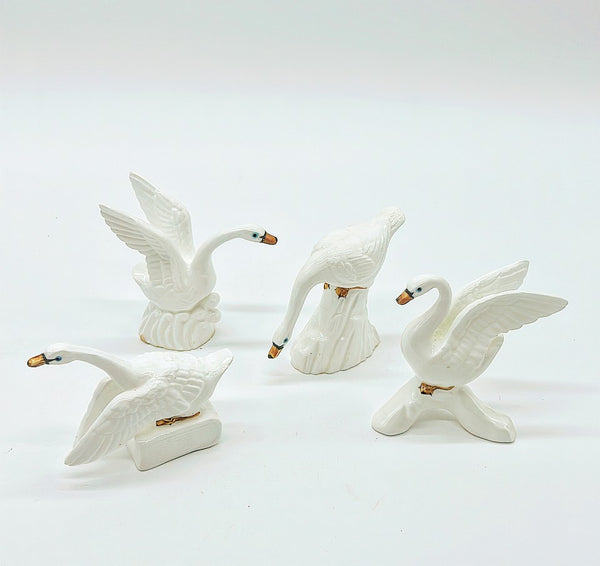 Set of 4 classic white decorative vintage swan figures.