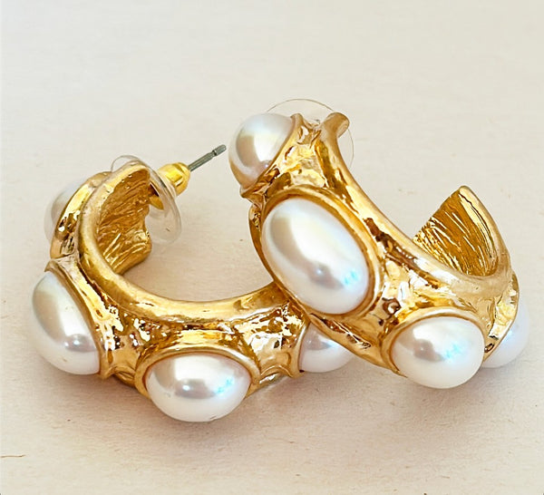 Classic pierced faux pearl hoop earrings.