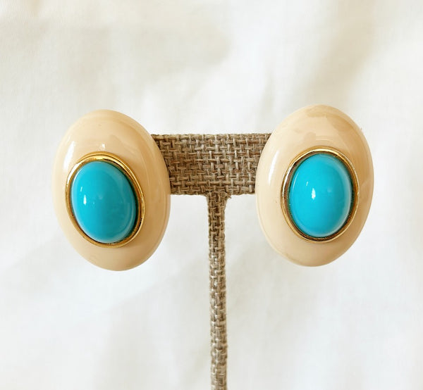 Classic Kenneth Lane signed creamy oval earrings with center turquoise colored bead & gold metal trim. Both signed