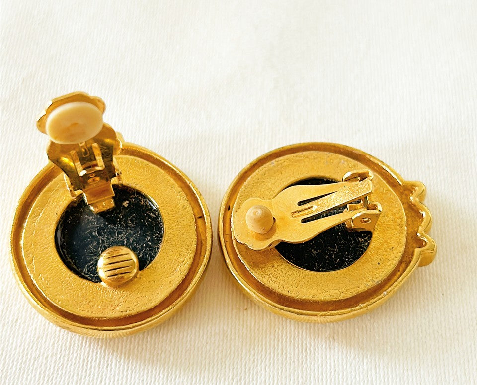 Classic round black intaglio style coin earrings with gold tome metal trim and cabachon style red stones at the base