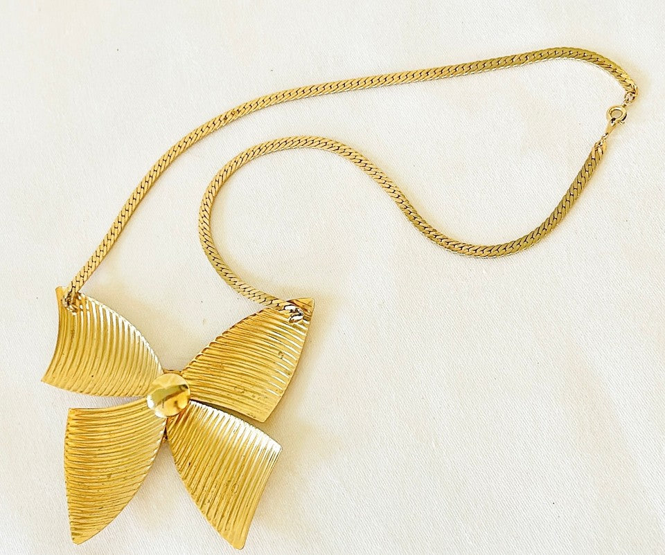 Adorable 80s gold necklace with extra large bow with rhinestone accents.