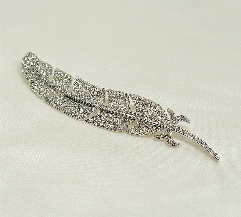 Classic signed Carolee rhinestone encrusted feather designer brooch.