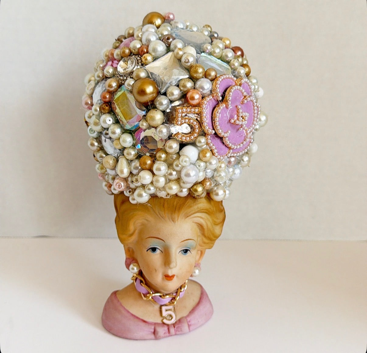 Vintage lady vase with vintage jewelry hat