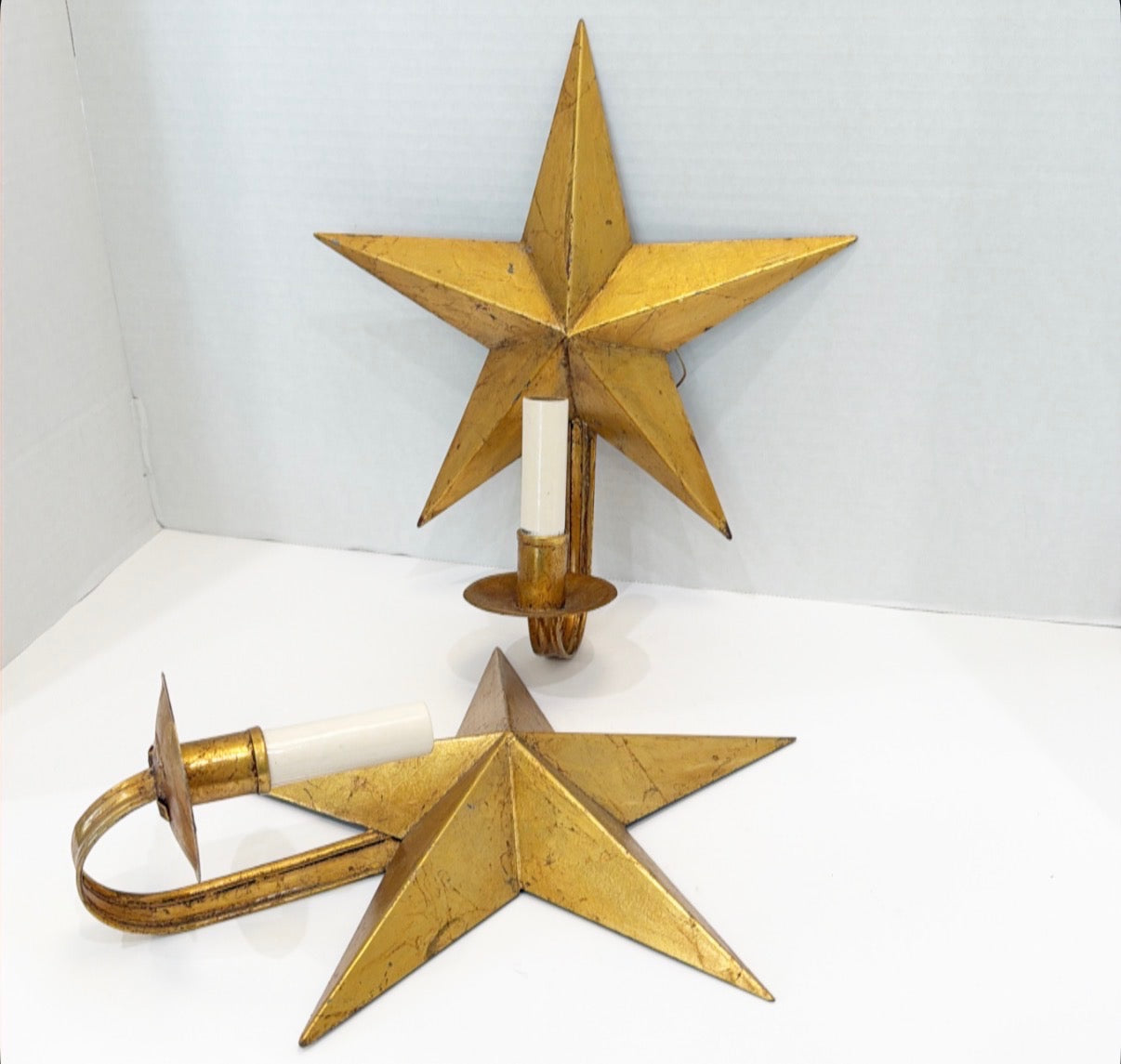 Pair of tole metal gold gilded star electric wall sconces.