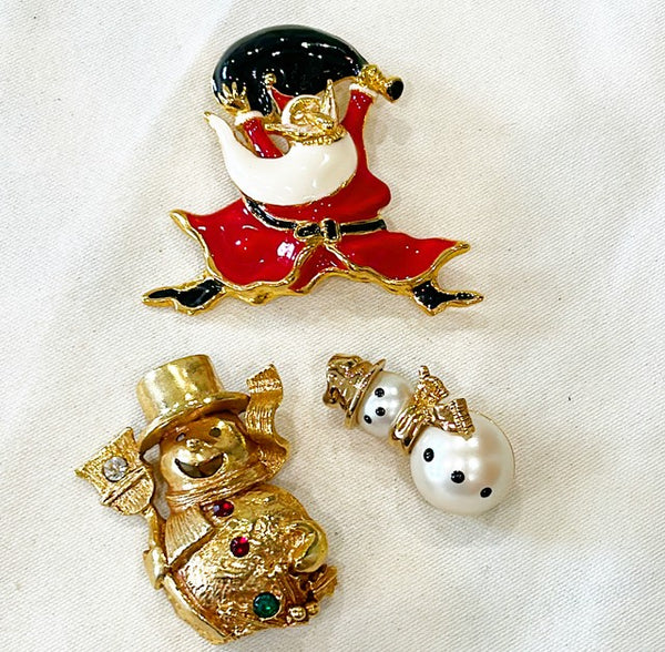 Vintage collection of Christmas themed brooches.