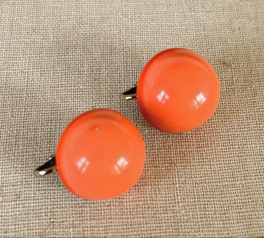 Fun vintage coral orange colored acrylic ball clip earrings from the late 1960s