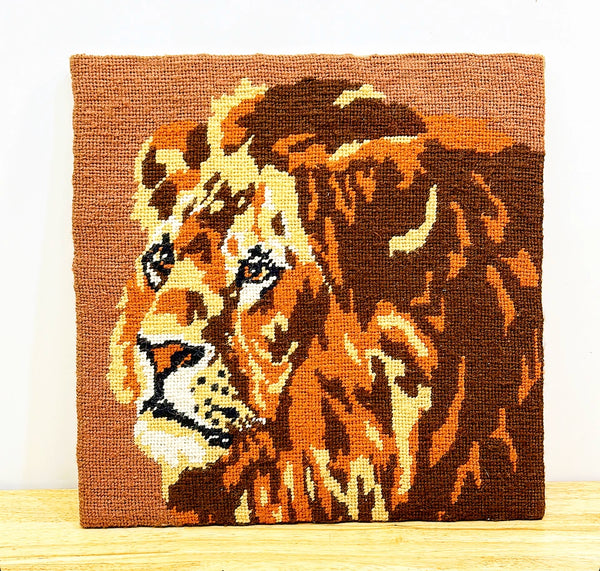 Hand stitched vintage needlepoint artwork of lion.