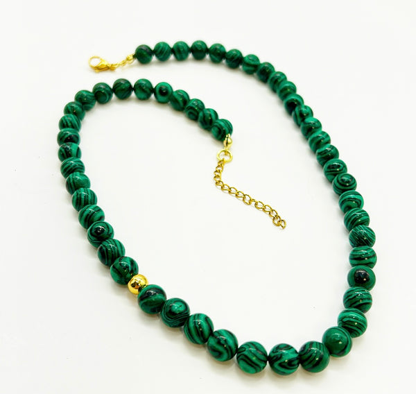 Vintage smaller scale malachite beads wit a gold time bead accent.