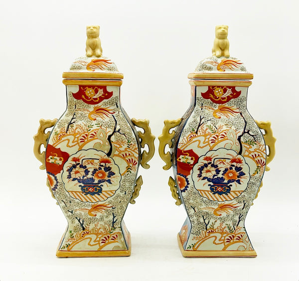 Pair of vintage Imari style vases with foo dog style lids.