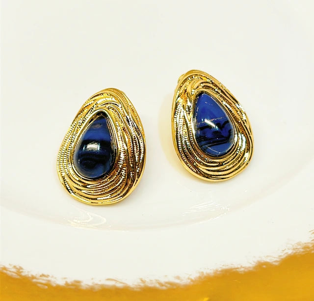 Teardrop shaped pierced earrings with faux lapis stone accents