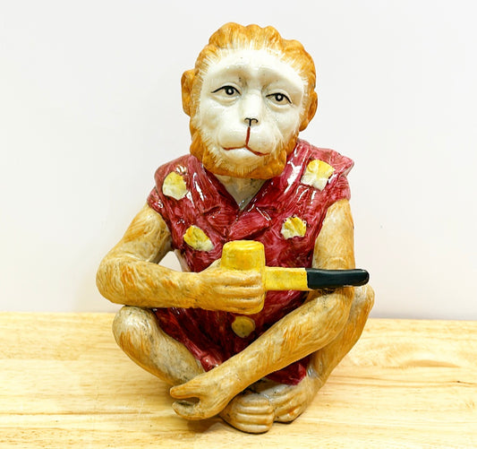 Chinoiserie style vintage monkey figure holding a tobacco pipe.