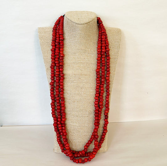 Extra long vintage necklace of triple strand of coral texture beads.