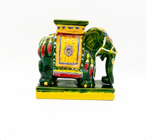 Vintage green and yellow elephant decorative figure with pink accents and tassels