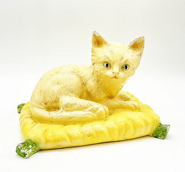 Mid century 1960s Italian style kitty laying in a yellow pillow with green tassels.