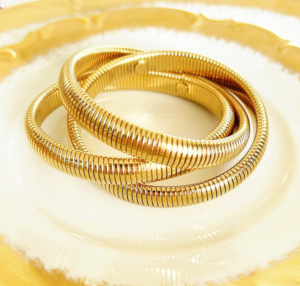 Gold omega style stretch metal bracelet.