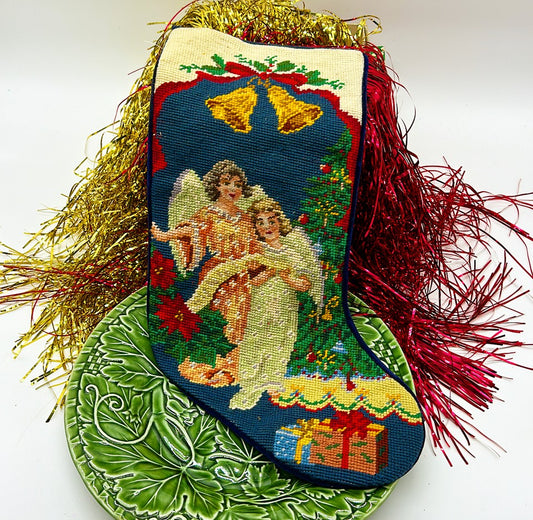 Vintage 1980s needle point Christmas stocking with Angels next to Christmas tree solid navy blue velvet back.