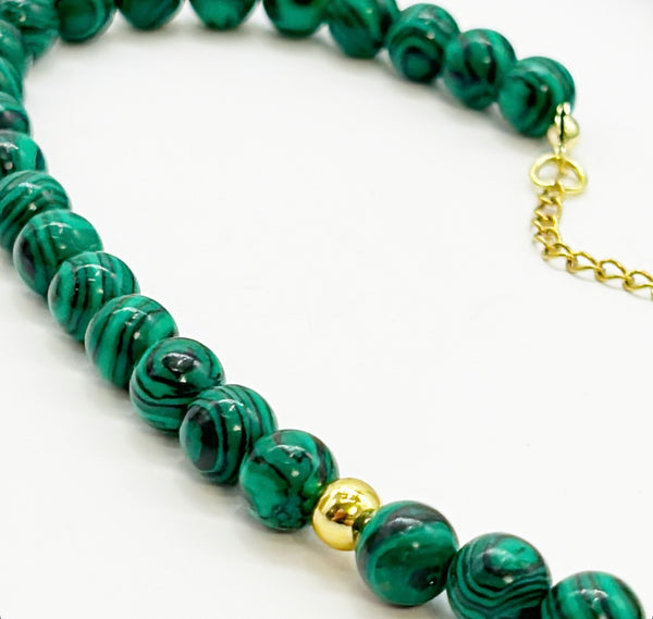 Vintage smaller scale malachite beads wit a gold time bead accent.