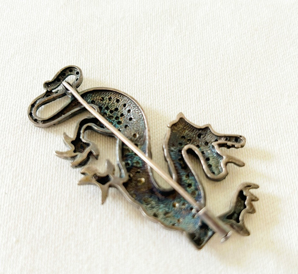 Rare chinoiserie style dragon brooch in a darker silver metal finish