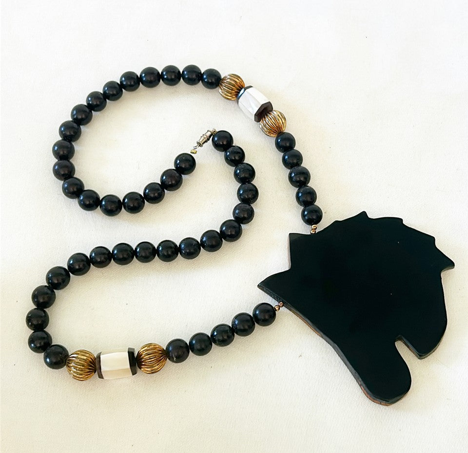 How fun is this? 1980s designer style black beaded necklace with wooden carved lacquered zebra pendant.