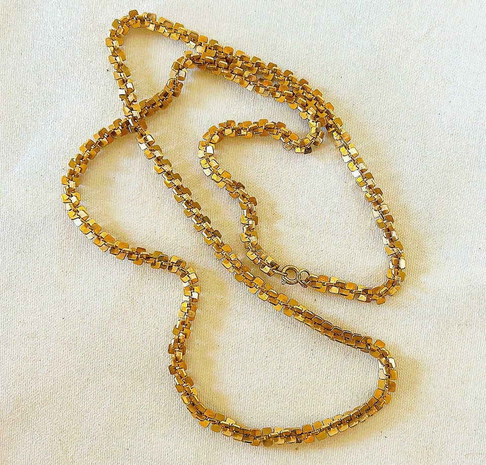 Beautiful vintage 80s long gold tone metal necklace with interlocking style squares as the chain design.