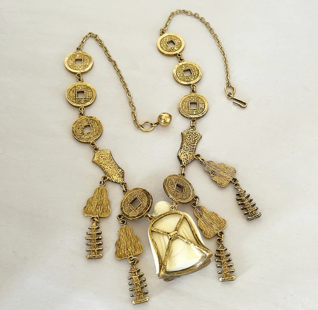 Vintage mid century modern 1960s signed Trifari Chinese faux carved Buddha coin necklace.