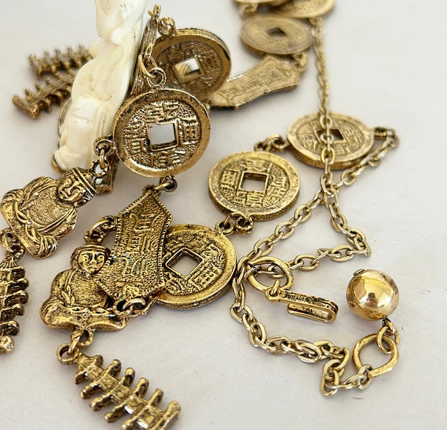 Vintage mid century modern 1960s signed Trifari Chinese faux carved Buddha coin necklace.