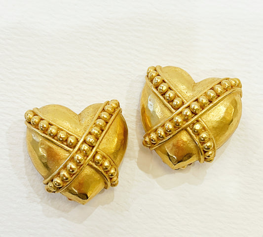 Vintage signed Carolee clip on gold metal heart shaped earrings.