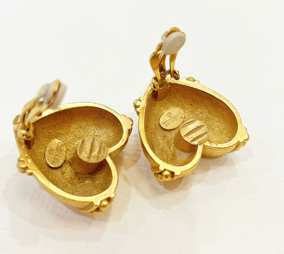 Vintage signed Carolee clip on gold metal heart shaped earrings.