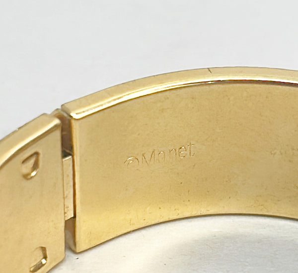 Vintage 1980s Monet signed hinged gold metal bracelet with clasp.