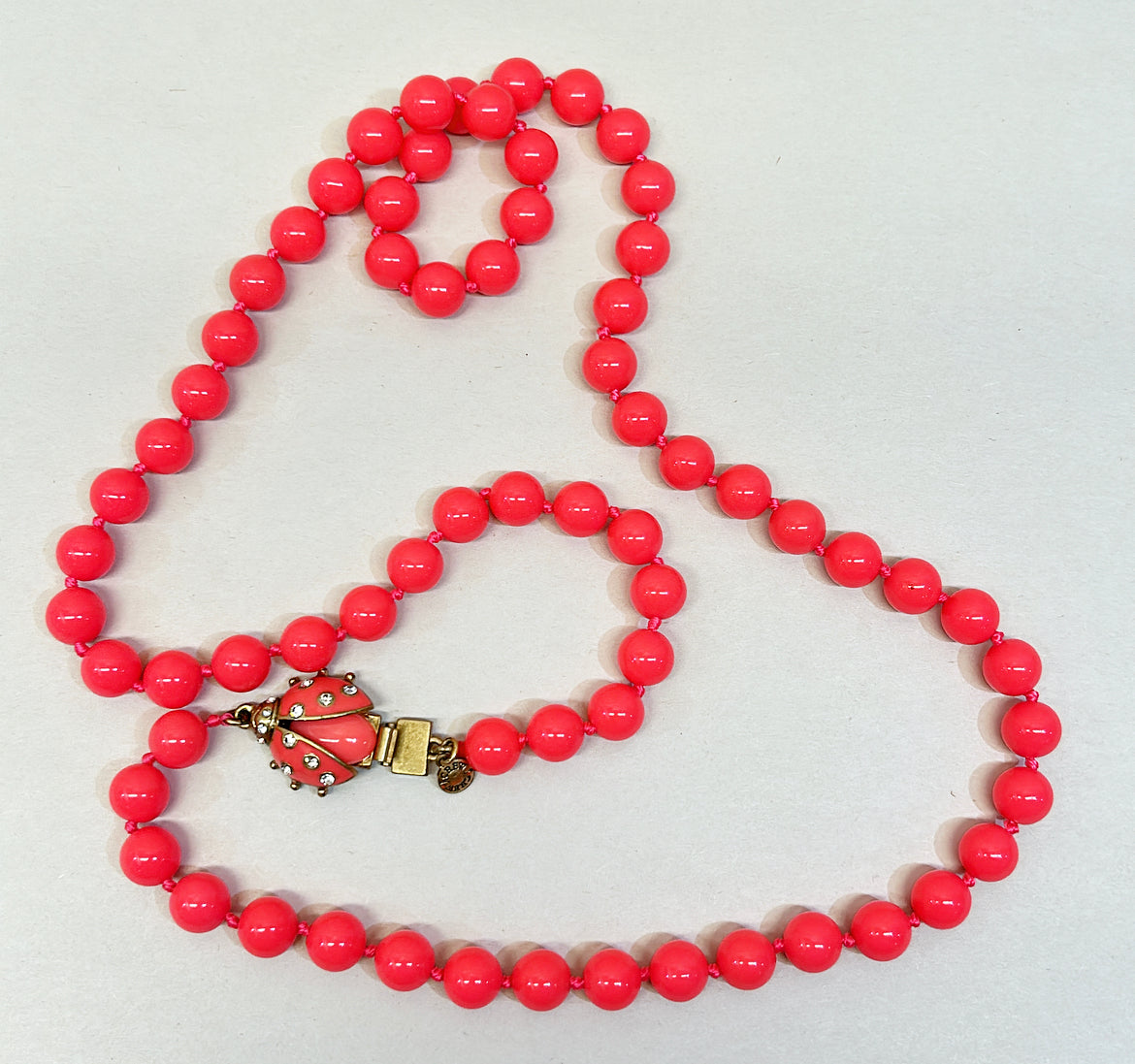 Vintage rare J Crew signed hot pink beaded lady bug necklace.