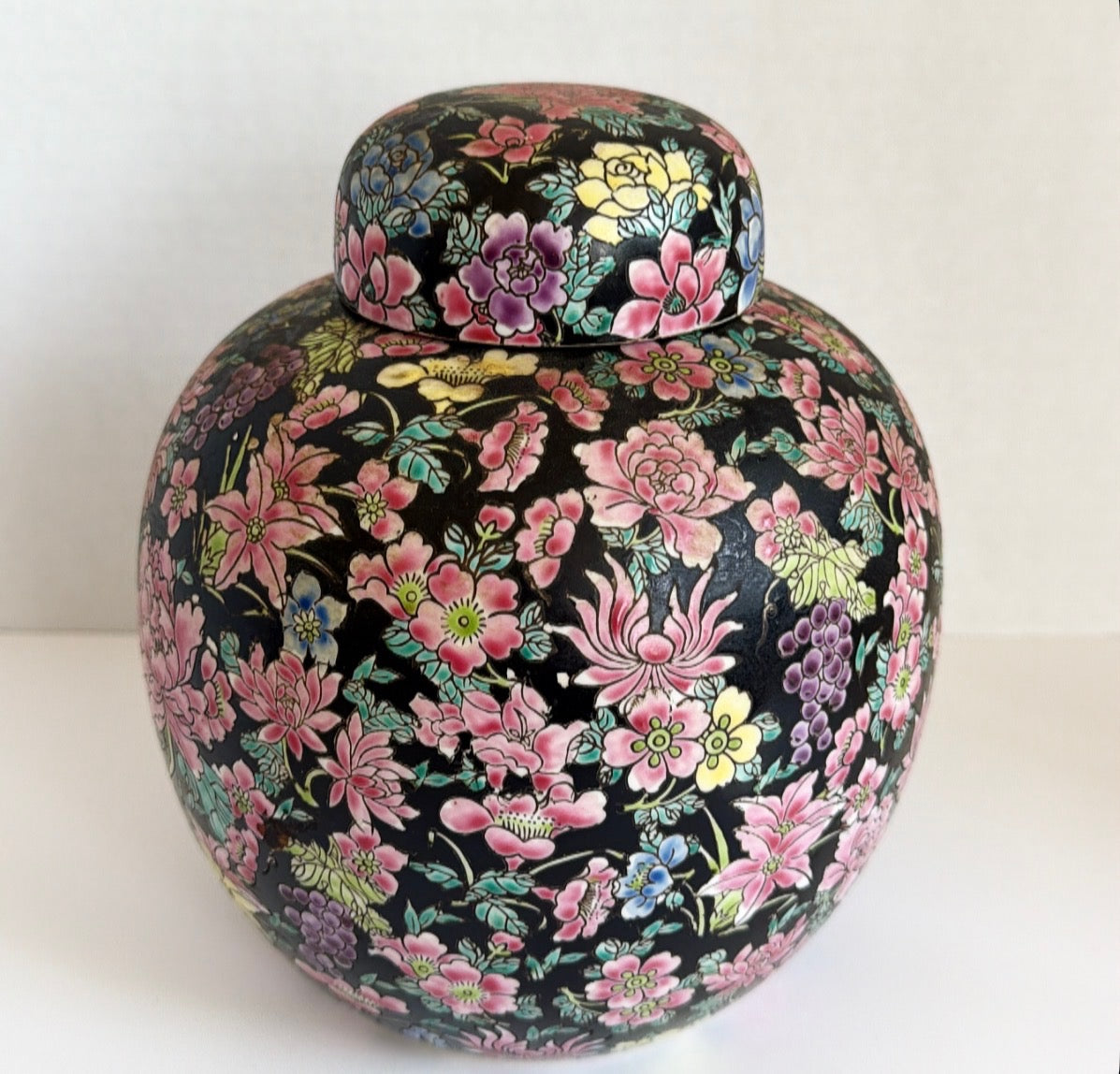 Vintage Ginger jar with black background and pink flowers