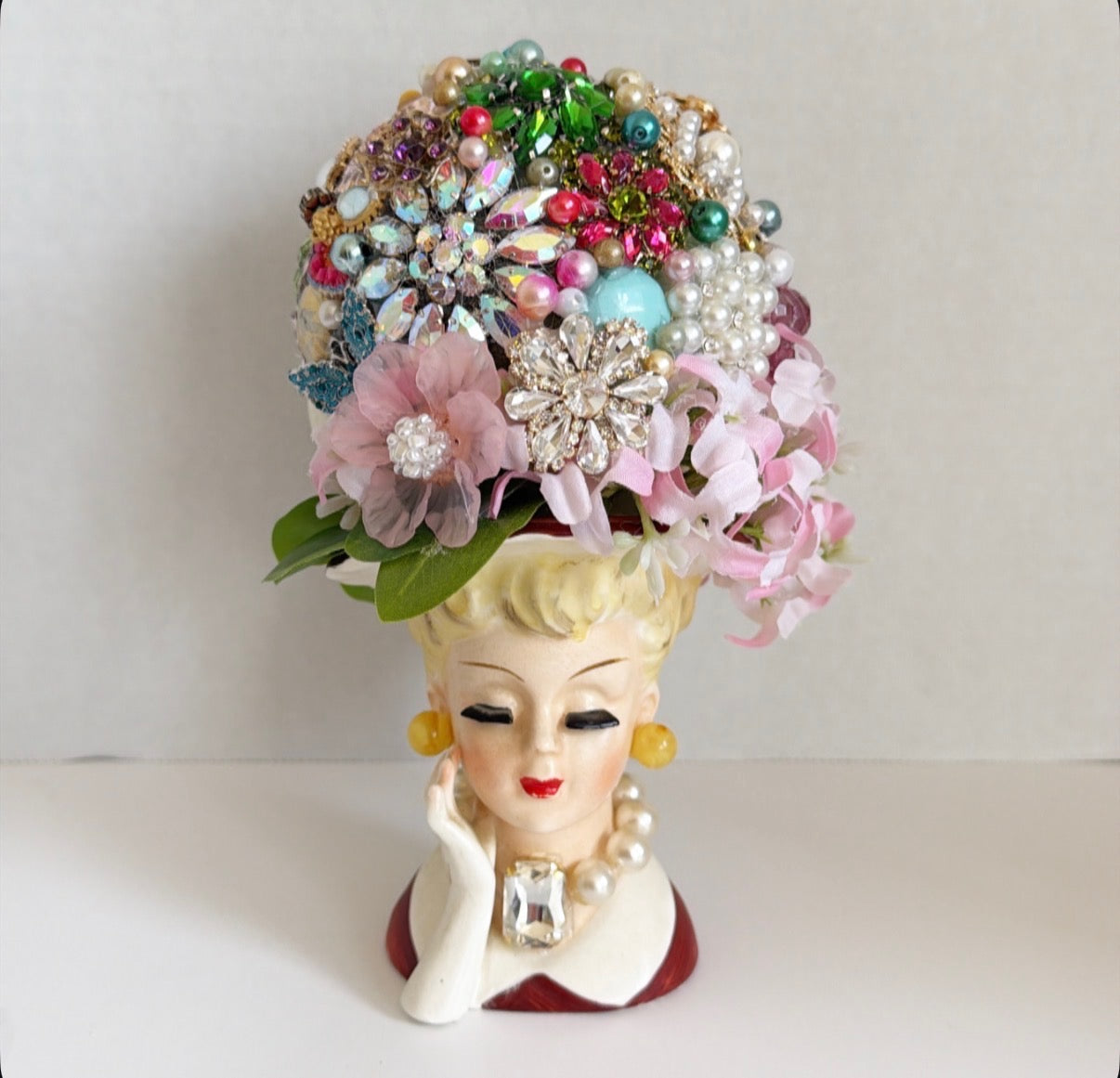Lady vase with decorative jewelry hat.