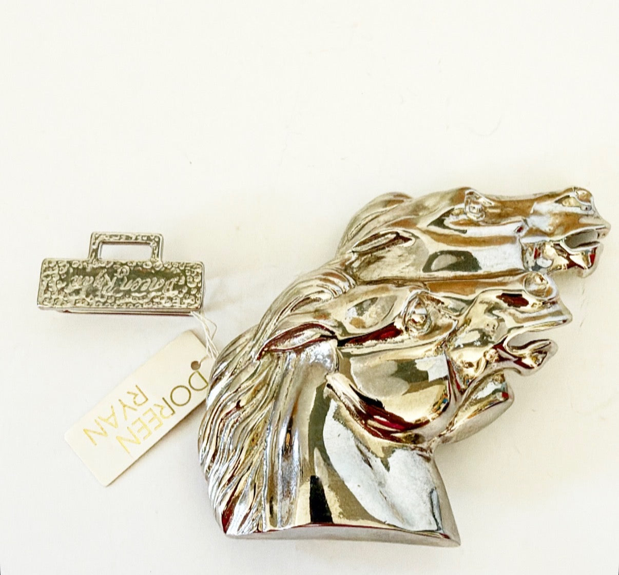 Vintage silver metal Doreen Ryan signed belt buckle.